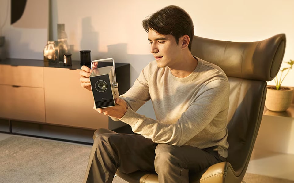 A man looking at an LG 4K projector