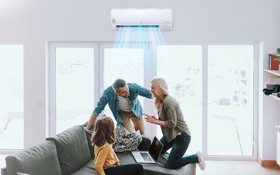 A family is talking in front of their home air conditioning system.