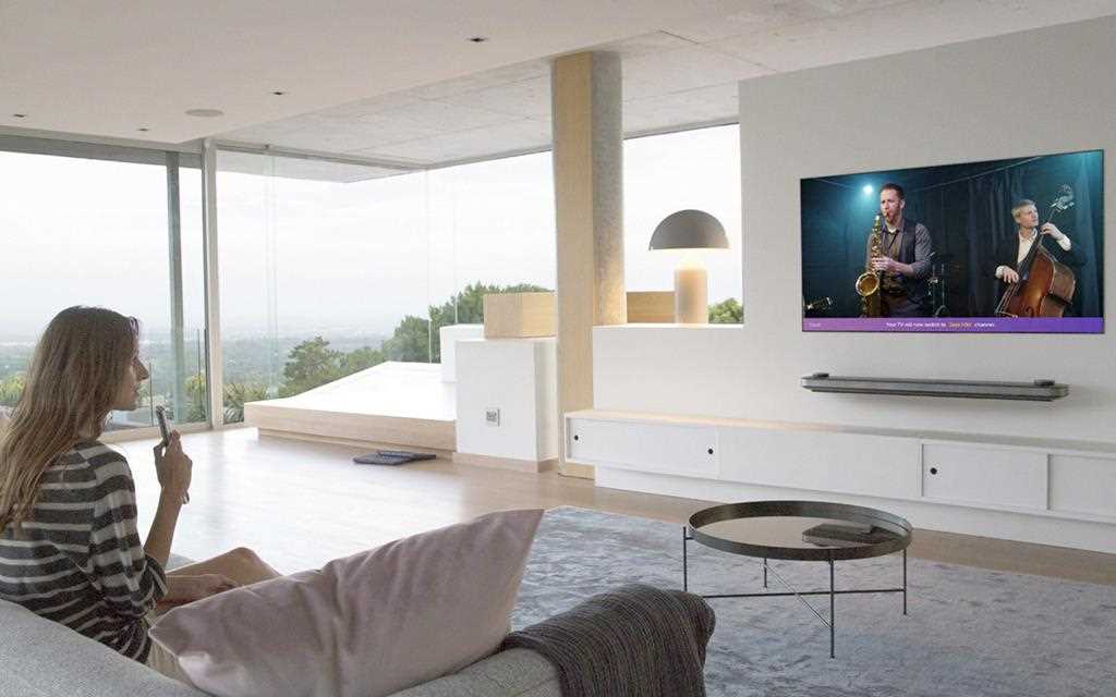 An image shows a woman testing the artificial intelligent enabled voice command from new lg super uhd tv.