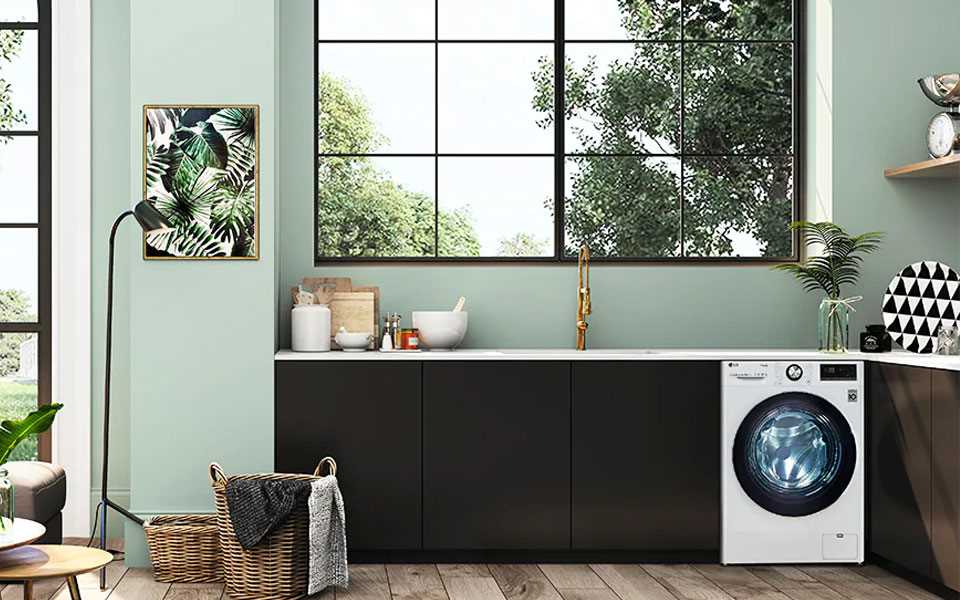 The LG TrueSteam washing machine featured in a home laundry room.