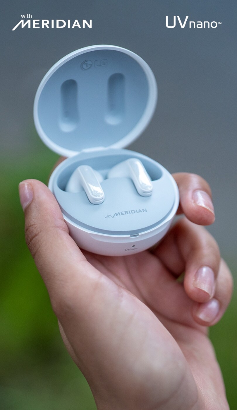 An image of a hand holding the new England limited edition LG TONE Free earbuds with noise cancellation.