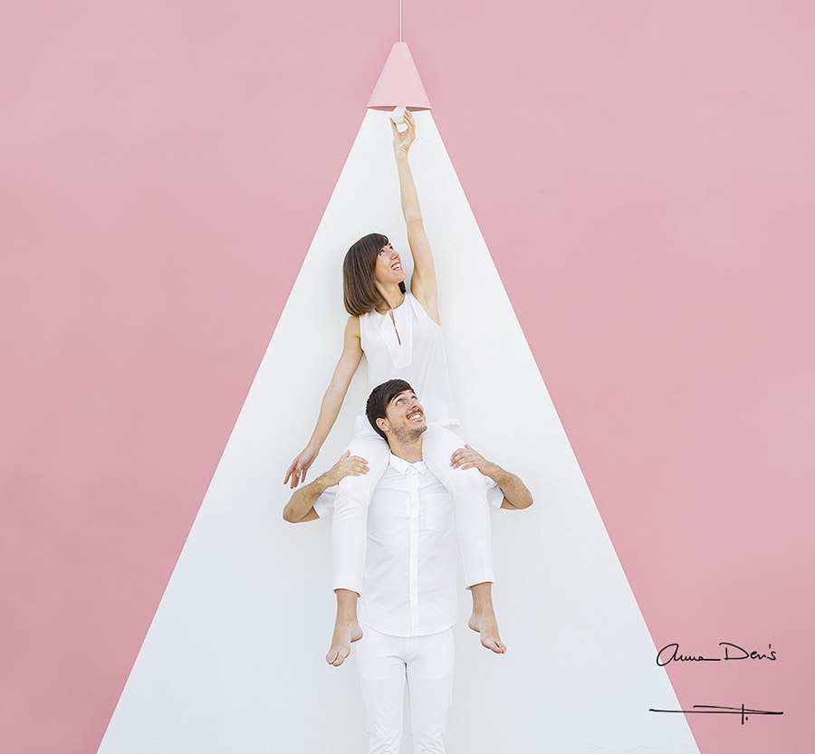 Anna und Daniel arbeiten an ihrem Kunstwerk in einem Raum mit rosa Hintergrund