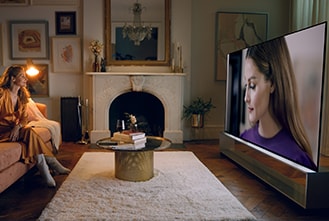 Olivia Palermo sieht sich selbst auf dem LG SIGNATURE OLED 8K-Fernseher im Wohnzimmer.