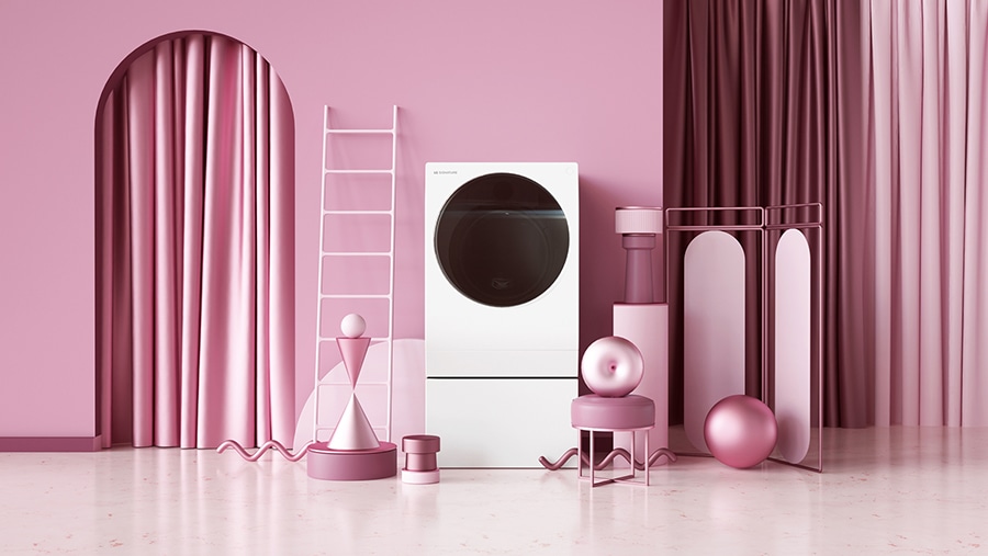 LG SIGNATURE Waschmaschine auf dem Boden mit verschiedenen rosafarbenen Objekten.