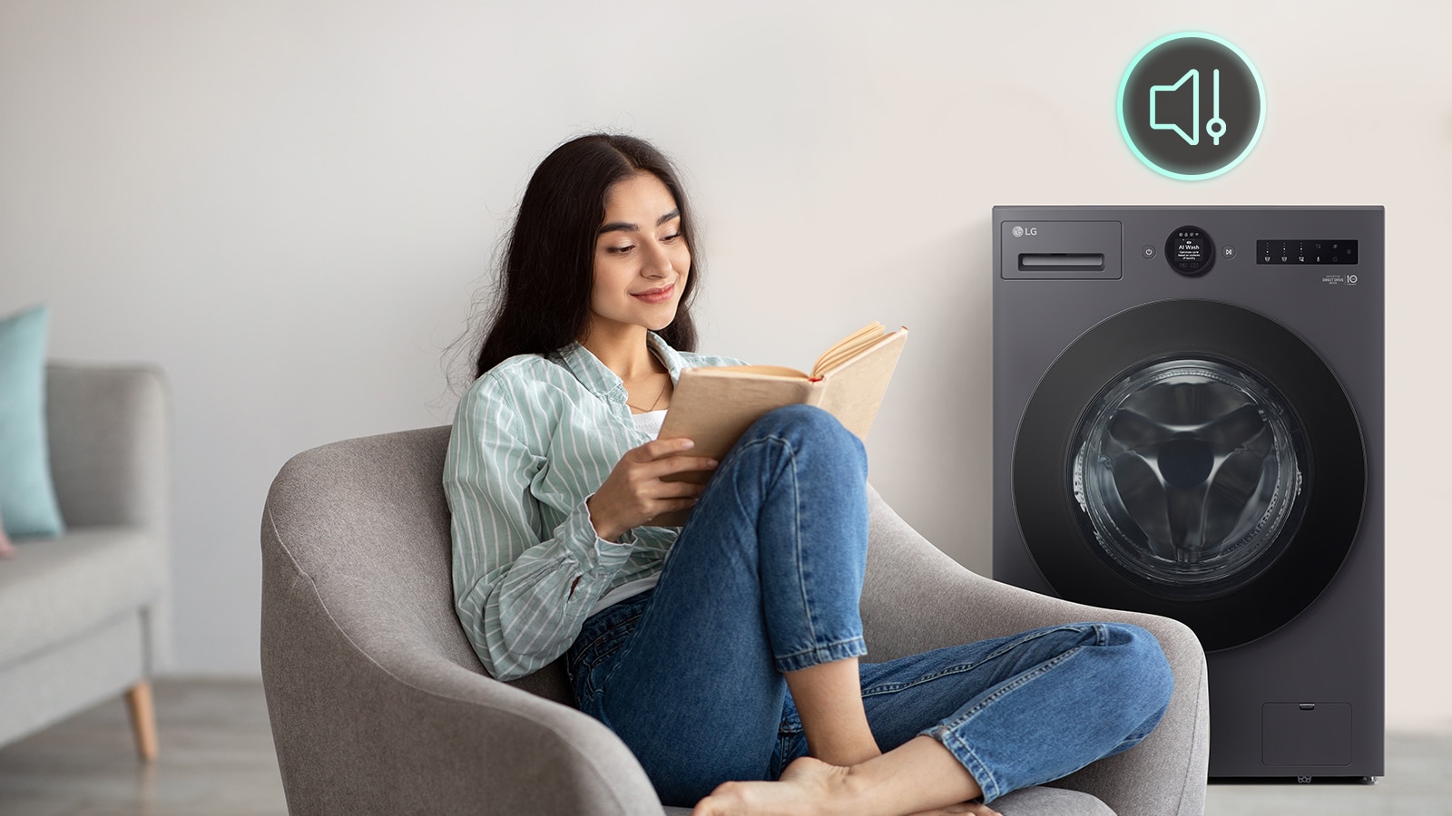 The woman is sitting on the sofa reading a book and showing a washing machine and a silent icon behind it