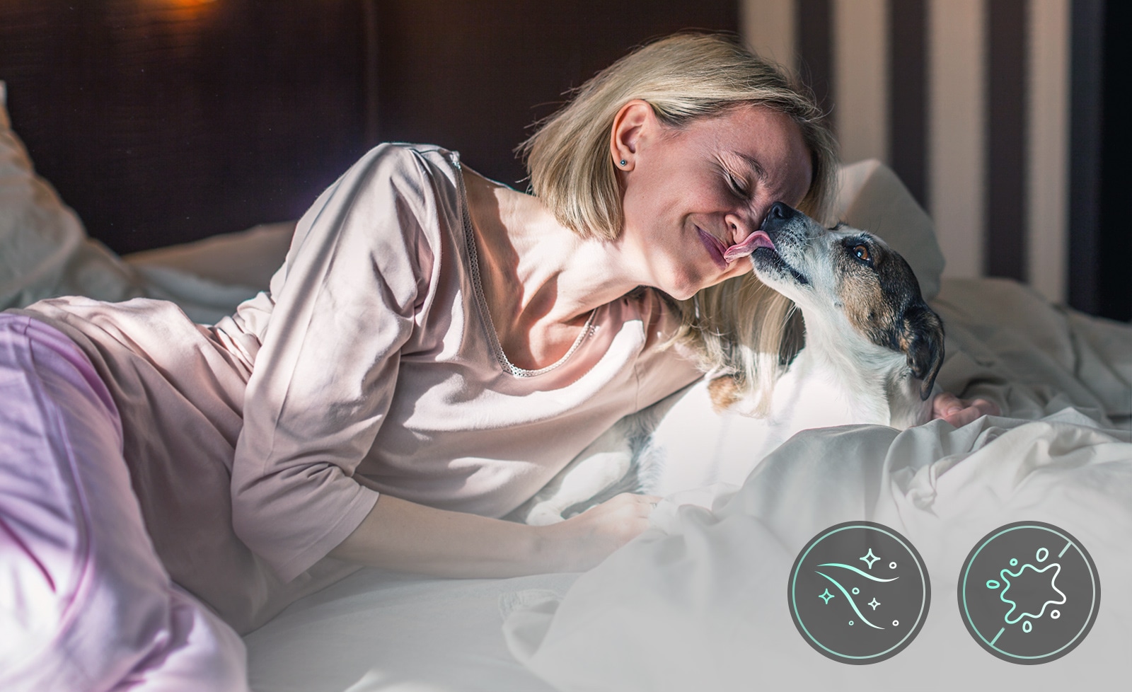 A woman and a dog are lying in bed