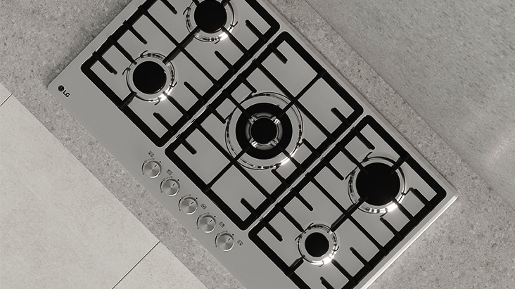 Top view of black gas cooktop with durable cast-iron grates designed for stable and secure cookware support.