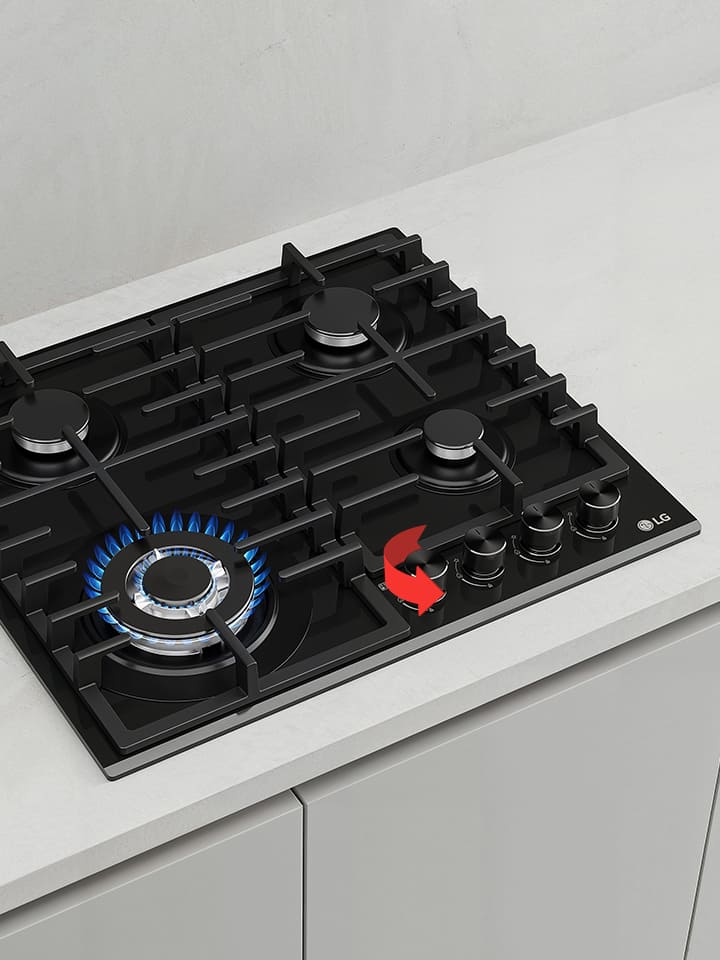 Close-up of black gas cooktop with blue flame burner and front rotary knobs for precise heat control adjustment.