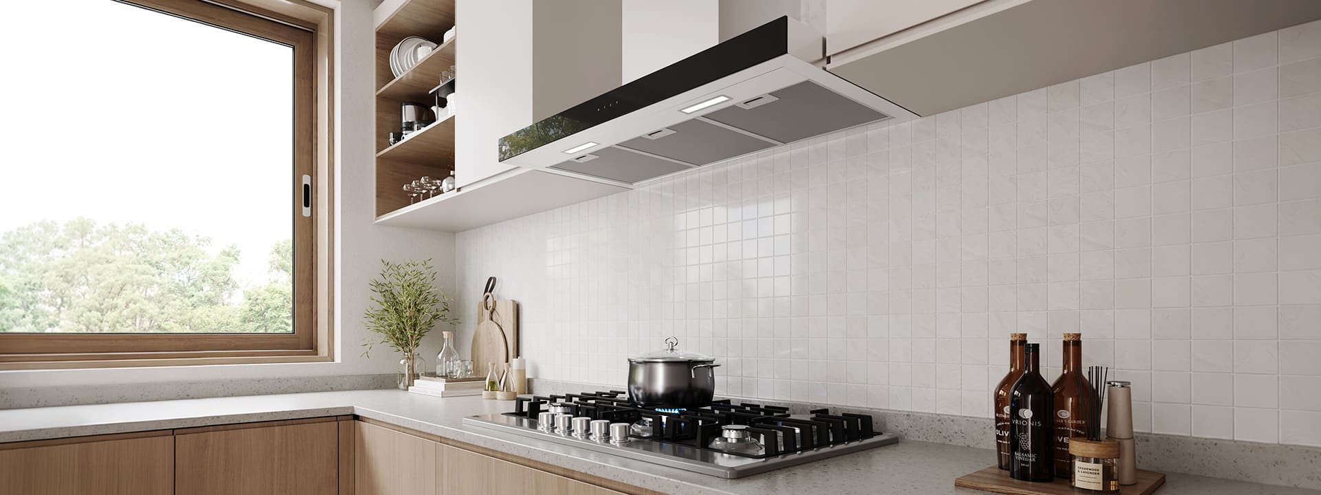 Modern kitchen interior featuring a built-in hood above a gas cooktop with a pot, against a white tile wall.