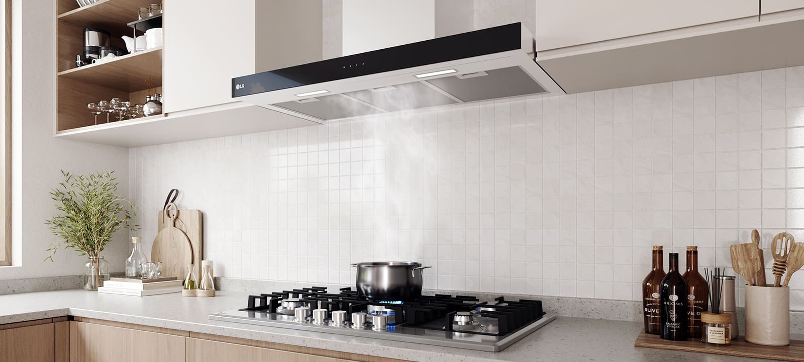 Modern kitchen interior featuring a built-in hood above a gas cooktop with a pot, against a white tile wall.