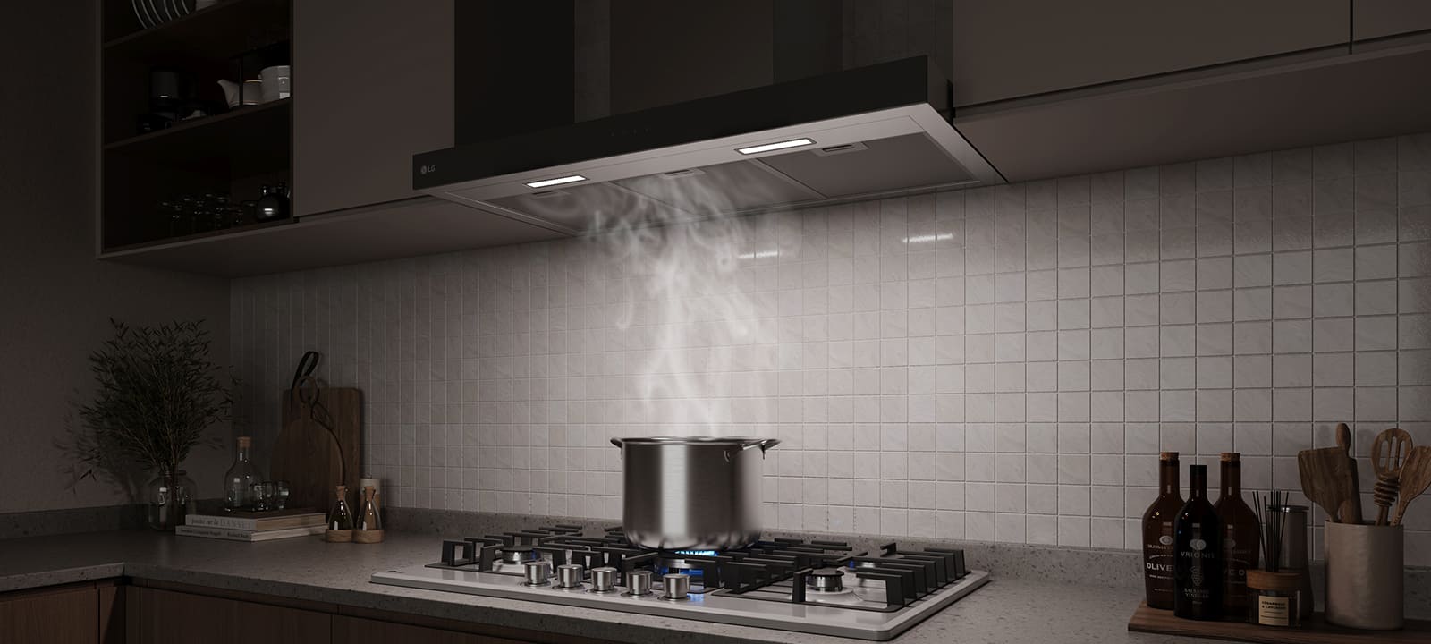 A built-in hood above a gas cooktop draws in steam rising from a pot while cooking in a modern kitchen.