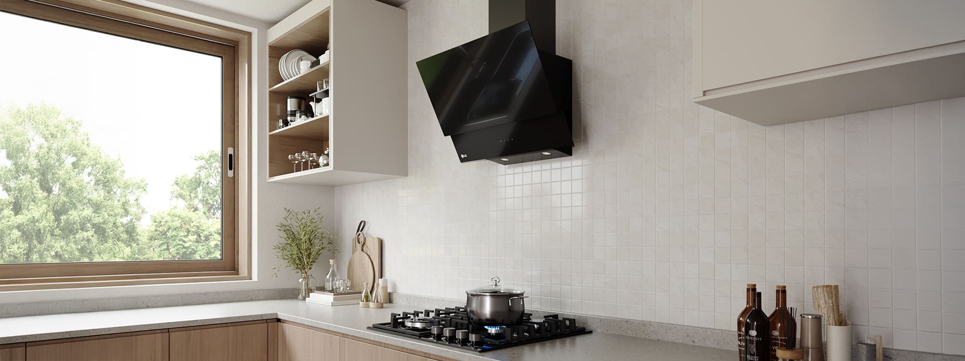 Modern kitchen interior featuring an angled glass hood above a gas cooktop with a pot, against a white tile wall.