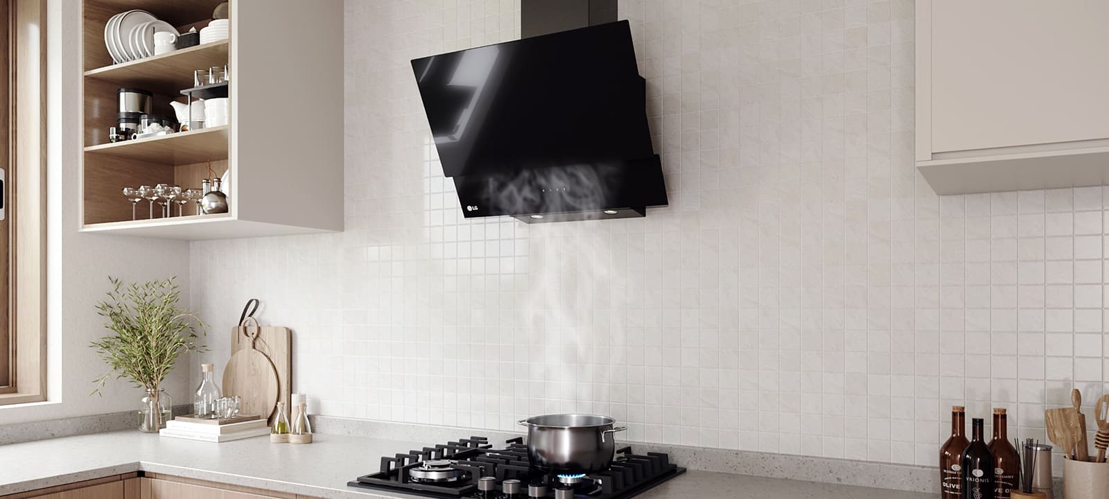 Modern kitchen interior featuring an angled glass hood above a gas cooktop with a pot, against a white tile wall.