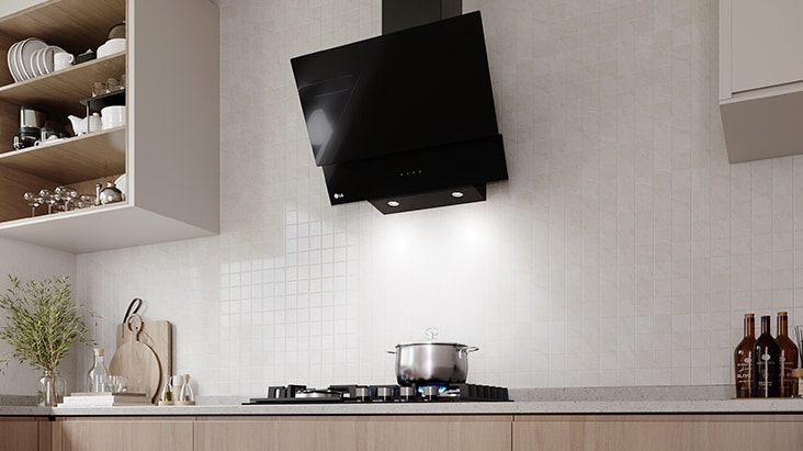 A black glass hood with LED lighting illuminates the gas cooktop and cooking area below.