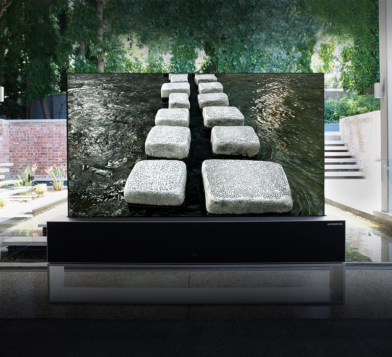 Rollable TV, situated in front of the pond of a luxurious house, showing step-stone bridge (scroll down the page)
