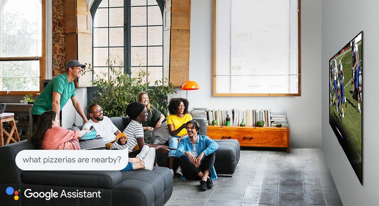 Woman watching football on TV with friends and asking the Google Assistant what pizzerias are nearby