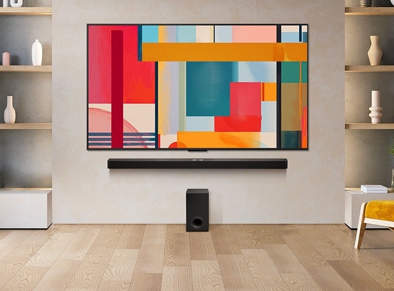 LG QNED TV mounted on a wall above a LG Soundbar in a modern living room space. LG QNED TV depicts an abstract background in green, red and orange.