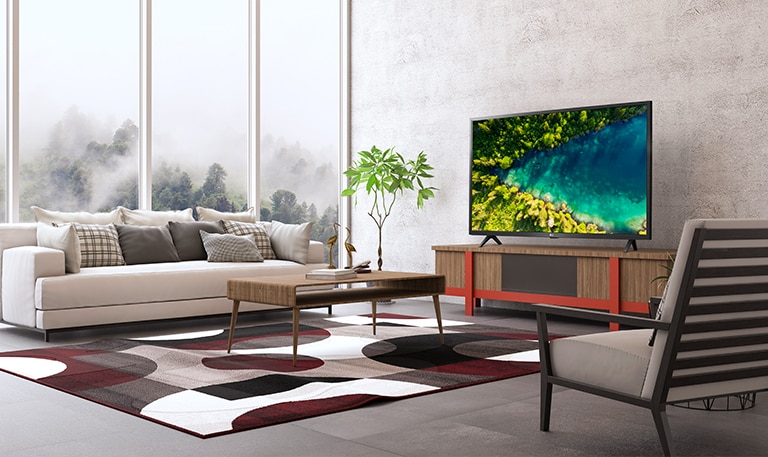 A TV that shows a river flowing in the dense forest of Top View from a modern and simple house setting.