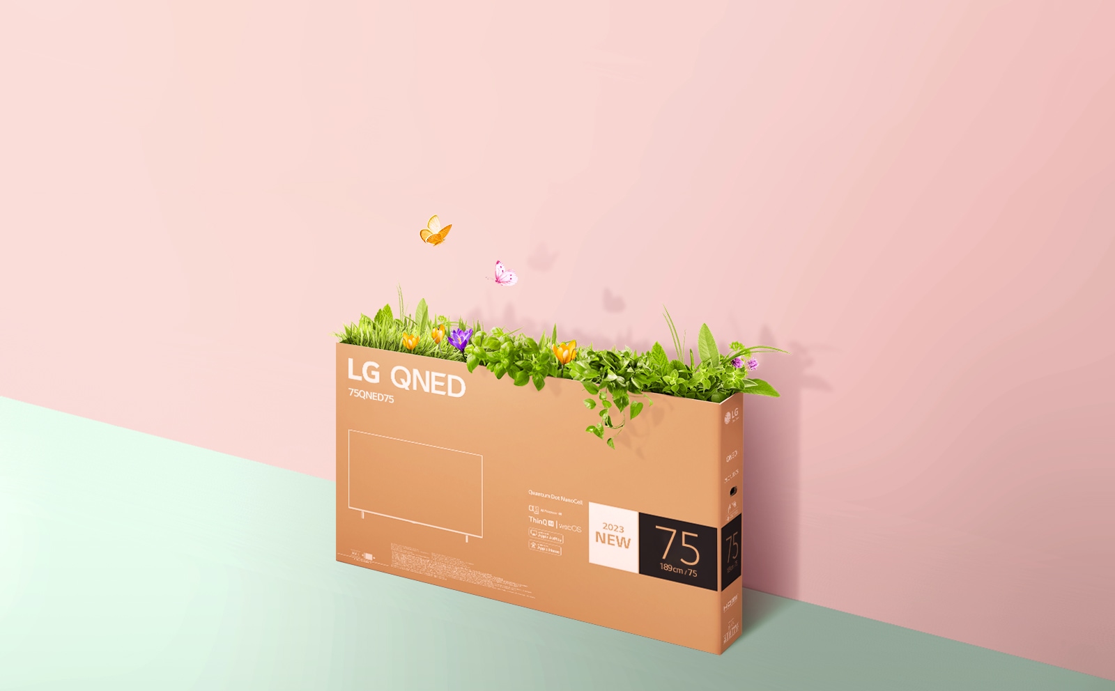 A QNED packaging box is placed on pink, green background and there is grass growing and butterflies coming out from its inside. 