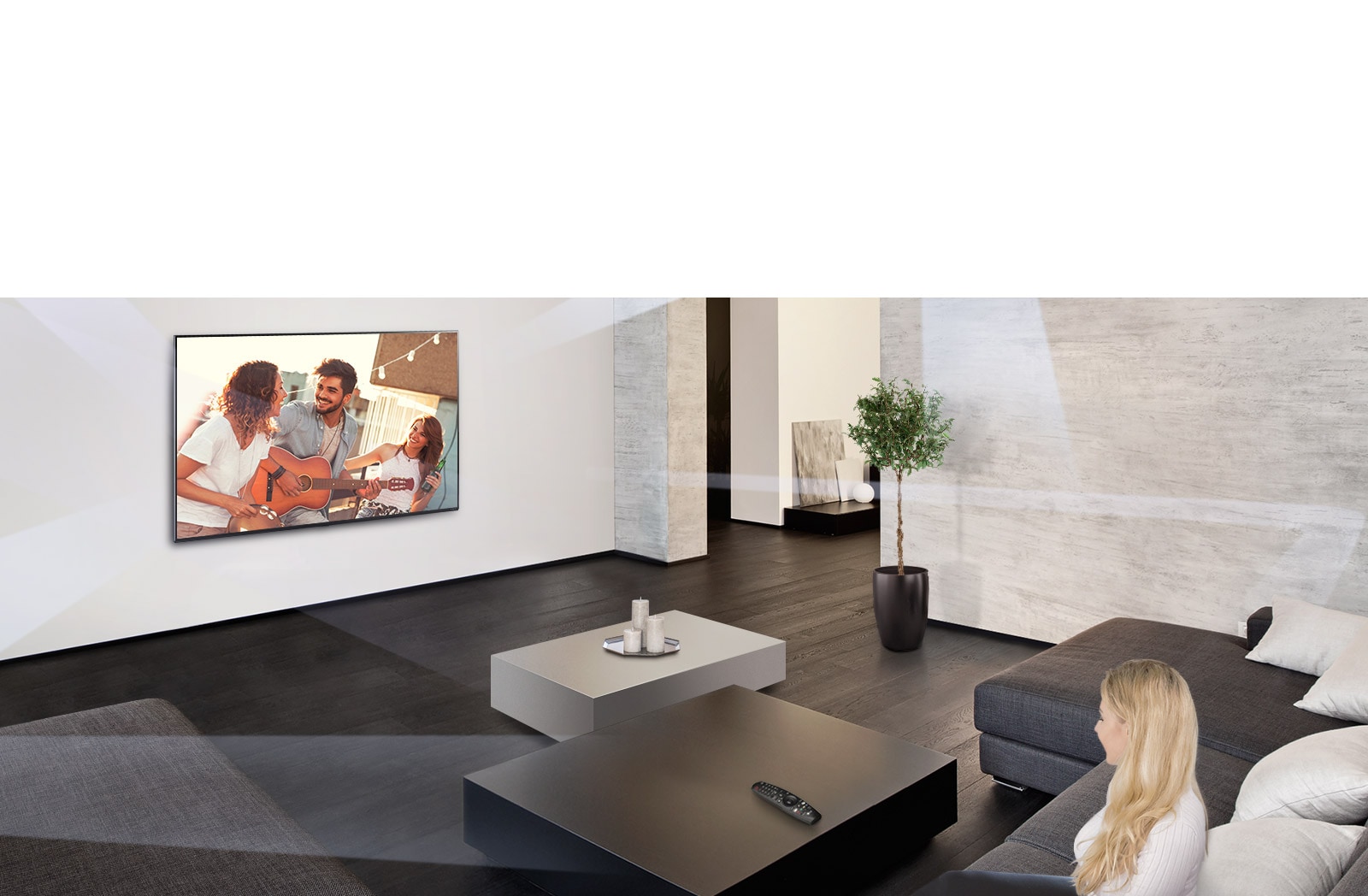 Women in the large and minimalistic living room watching people playing on TV.