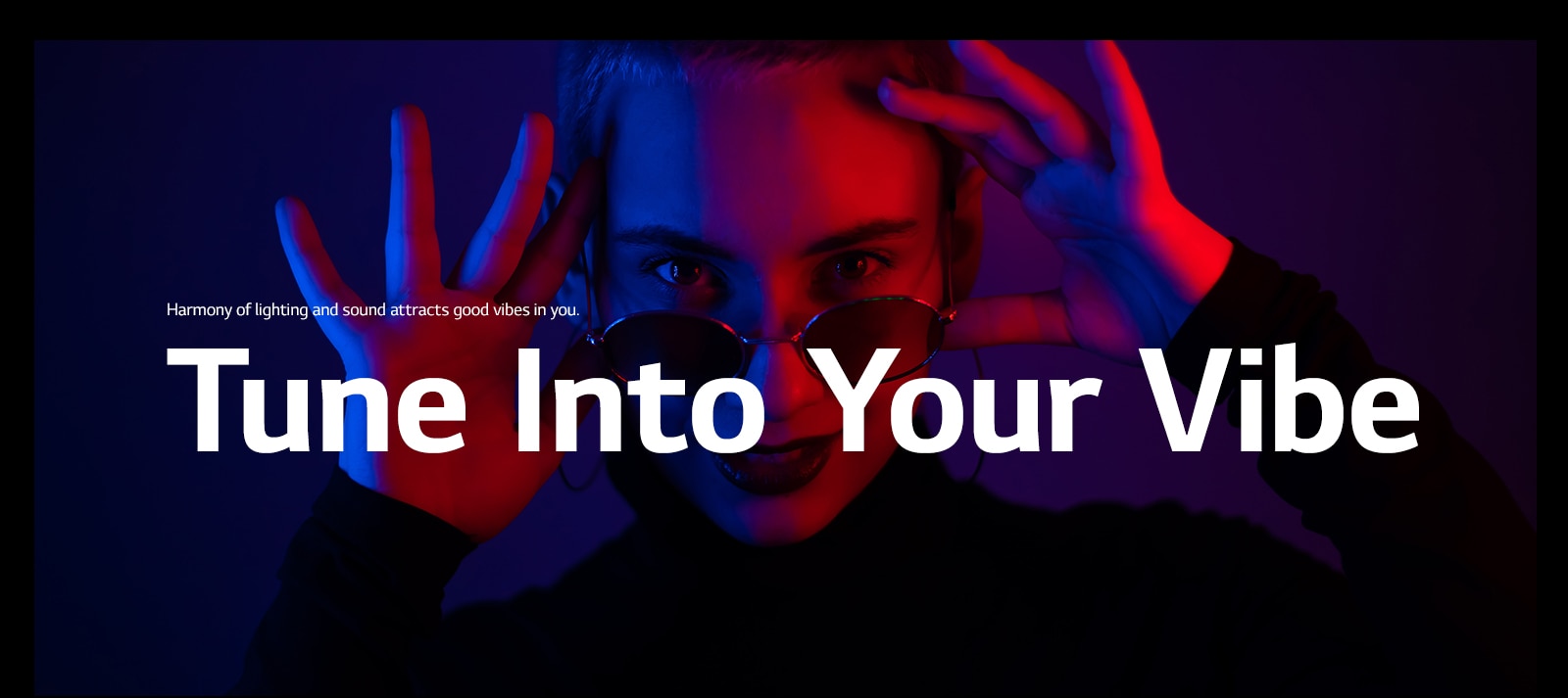 Woman strikes a pose in vivid lighting.