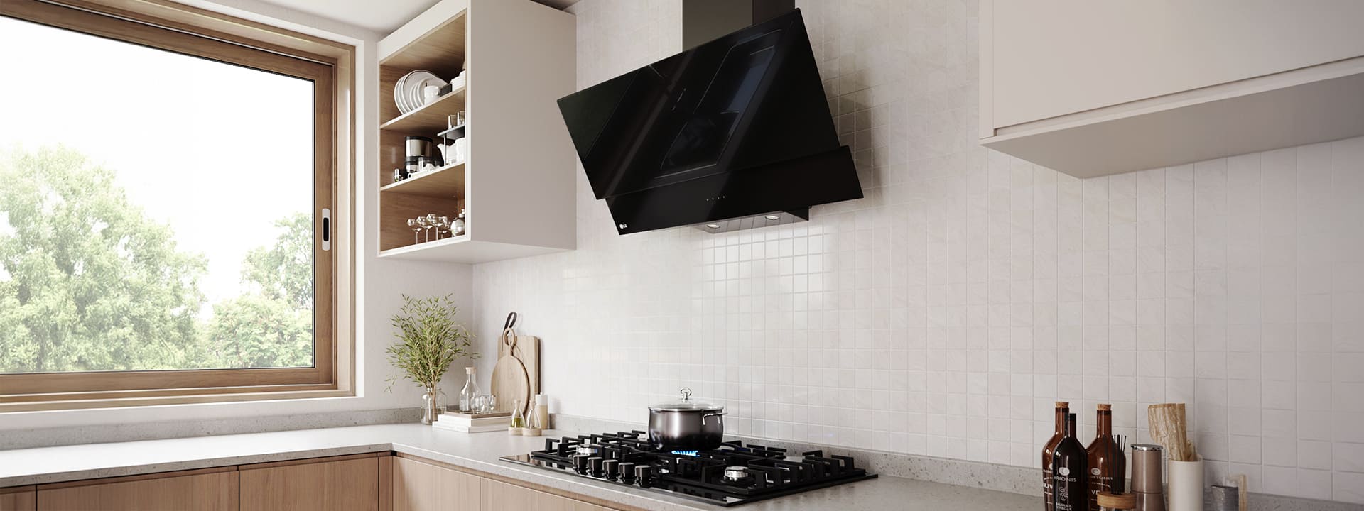Modern kitchen interior featuring an angled glass hood above a gas cooktop with a pot, against a white tile wall.