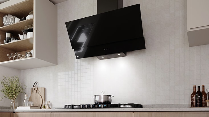 A black glass hood with LED lighting illuminates the gas cooktop and cooking area below.