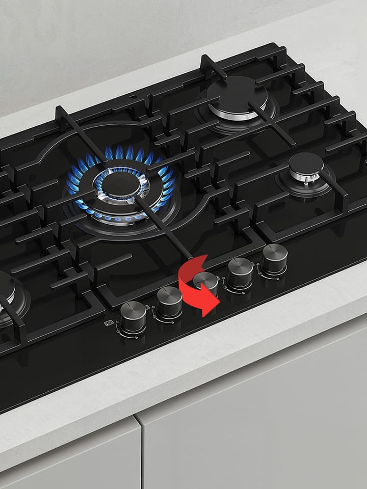 Close-up of black gas cooktop with blue flame burner and front rotary knobs for precise heat control adjustment.