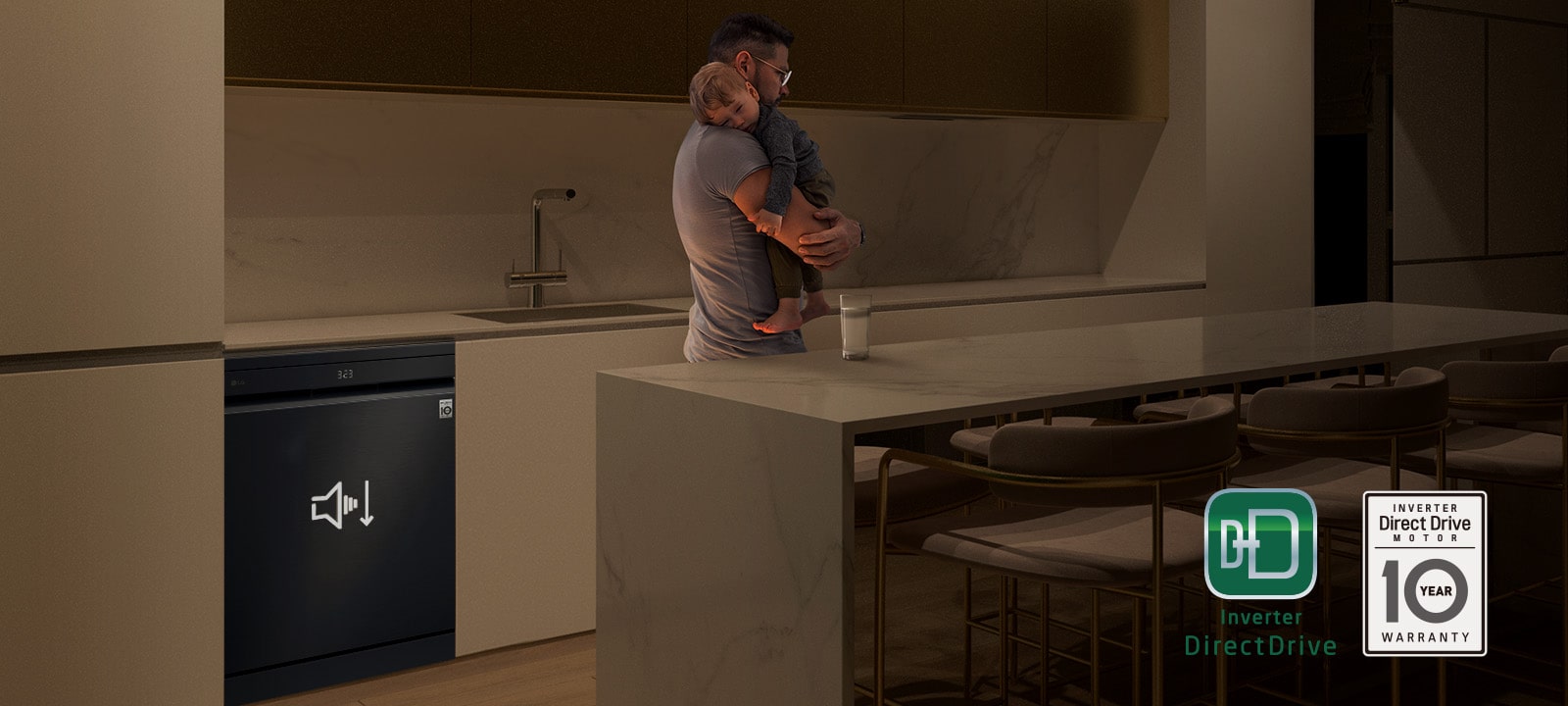 Man holding a sleeping child while a quiet dishwasher runs in the background