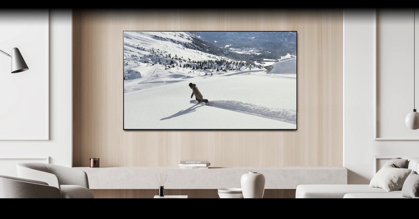 In the living room, there is a TV on the wall displaying a video of a person skiing. A message bubble saying "Send screen to bedroom TV" appears at the bottom of the screen, causing the TV to turn off and the video to continue playing on the bedroom TV. Another message bubble saying "Send screen to living room TV" appears, causing the video to switch back to the living room TV and the bedroom TV to turn off.