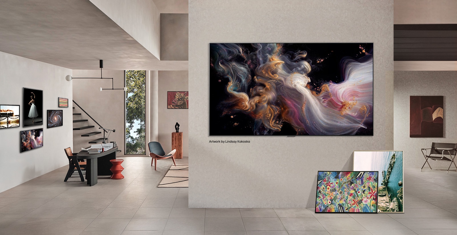 Interior of a sophisticated home. Lots of different artworks are displayed. On the center wall is an LG TV with popular artwork on the screen. The TV looks like a painting from a museum. 