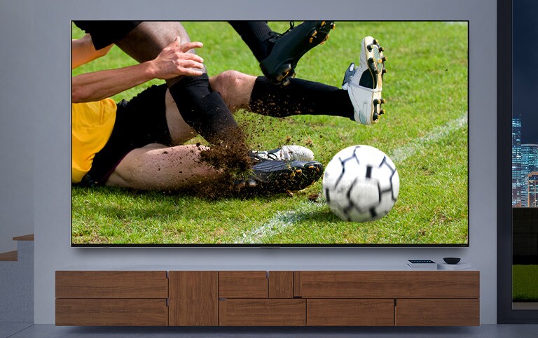 A TV screen displaying a close up of a soccer player tackling other player gets larger. Then the screen changes to cinematic image of space station as the interior changes to dark. At last, the screen changes once again to a game scene that a knight fighting against a dragon. (play the video)