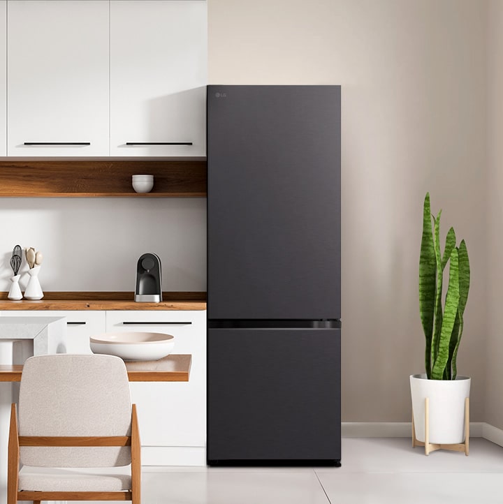 The front view of lg bottom freezer refrigerator with water dispenser in a white modern kitchen room.