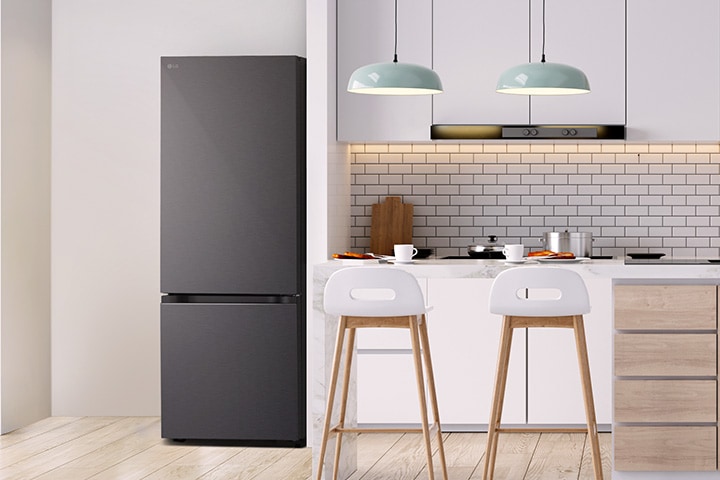 The overall view of  lg bottom freezer refrigerator with water dispenser in a kitchen.