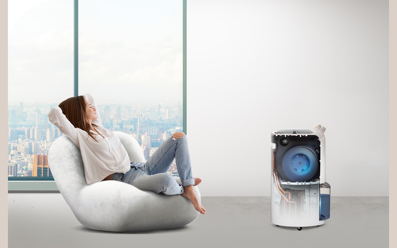 A woman is resting in a comfortable room where the dehumidifier is working, and inside the dehumidifier, it is seen that the UVnano fan is working.