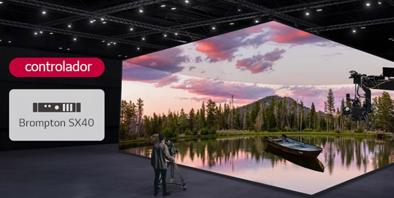 A virtual production studio which has curved LED walls and ceiling and floor LEDs is being filmed, and a compatible controller is being displayed next to it.