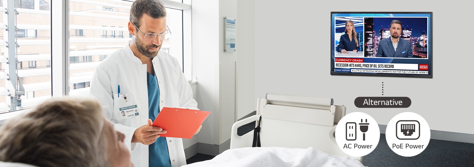 A patient is lying in the hospital room and watching a TV installed on the wall. The TV can be operated with AC power or PoE power.