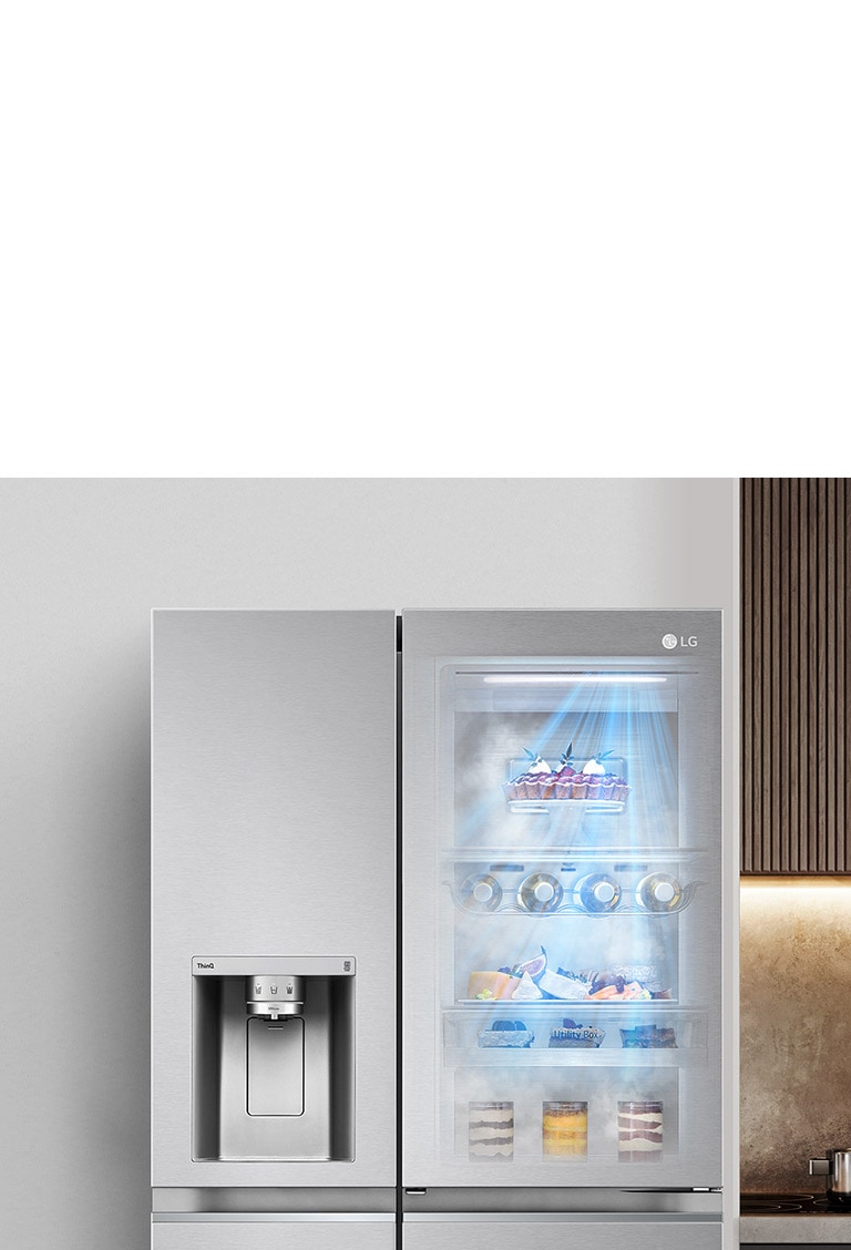 The front view of a black InstaView refrigerator with the light on inside. The contents of the refrigerator can be viewed through the InstaView door. The rays of blue light shine over the contents of the DoorCooling function.