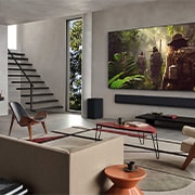 LG 65 pulgadas LG OLED evo AI G5 4K Smart TV 2025, Wide view of a living room inside a premium home, a man is watching a movie on his wall-mounted LG OLED TV. The TV's design blends elegantly with the wall and the interior design., OLED65G5PSA, thumbnail 13
