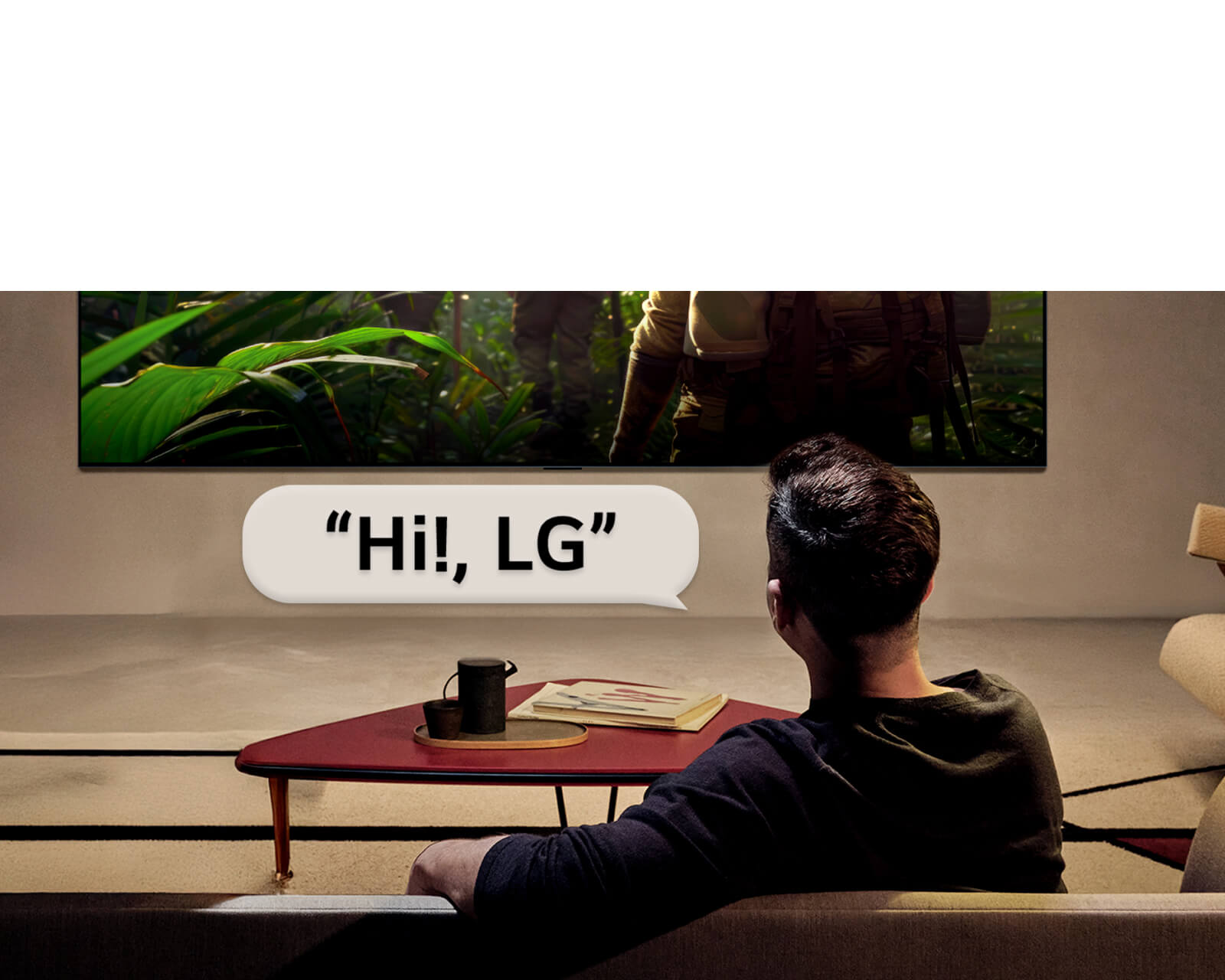 LG OLED evo AI C6 with Far Field Voice Recognition is activated through a voice command as a person seated in a room says “Hi, LG” toward the TV, indicating hands-free voice interaction within the TV interface.