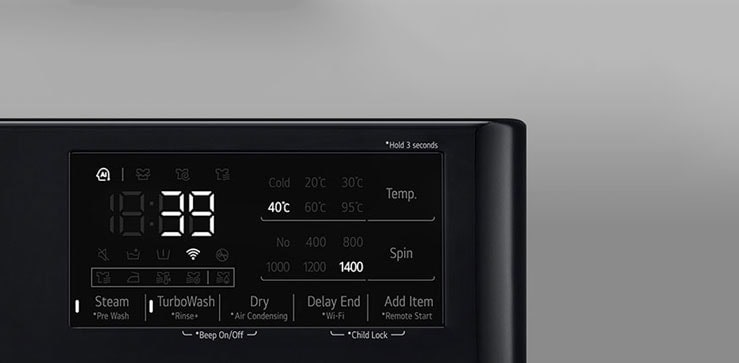 See on suurendatud kujutis pesumasina paneelil olevast metallnupust.