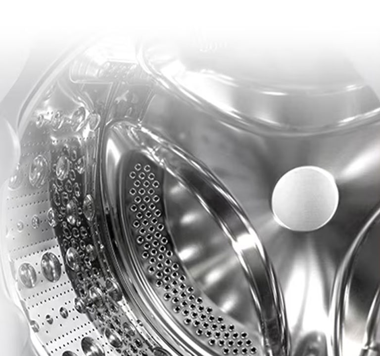 Vaade pesumasina sisemusse, millest paistab roostevabast terasest tõstuk.