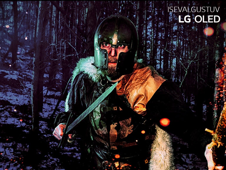 LG/LED ja LG OLED-värvide taasesituse võrdlusliugur, mille pildil on turvises mees talvises metsas