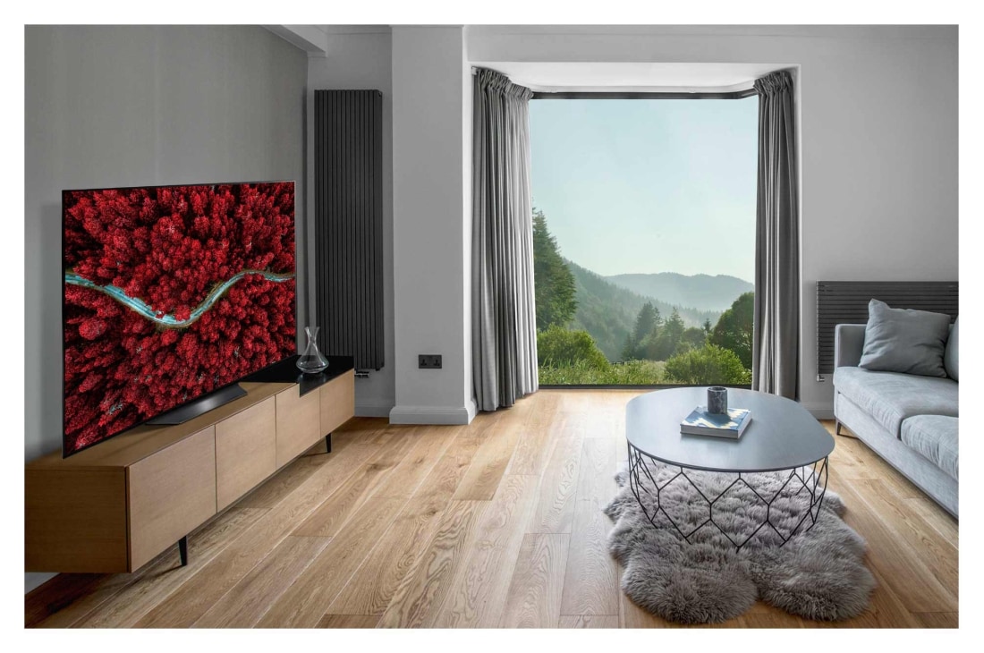 LG 55-tolline OLED 4K teler koos G-Sync™ ja helisüsteem Dolby Atmos, Living room with a sofa and a TV showing an aerial view of nature, OLED55BX3LB, thumbnail 11