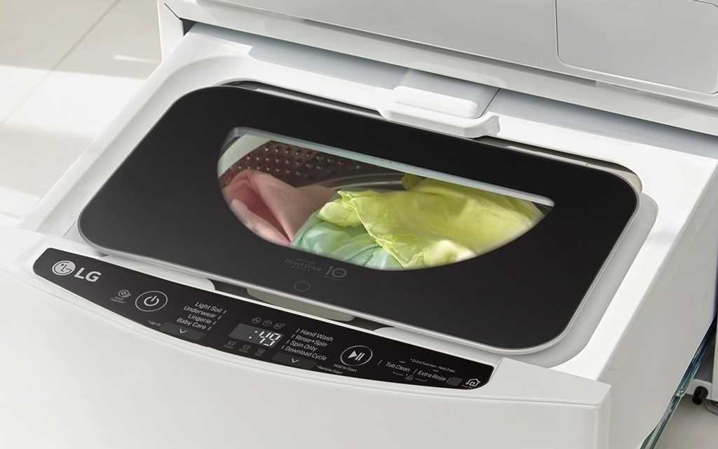 A birds eye view of the LG TwinWash washing machine, with a close up of the bottom washer with laundry inside