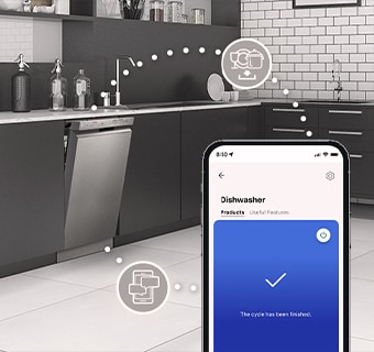 Kitchen interior with partially open free-standing dishwasher and LG ThinQ™ app showing cycle complete notification.