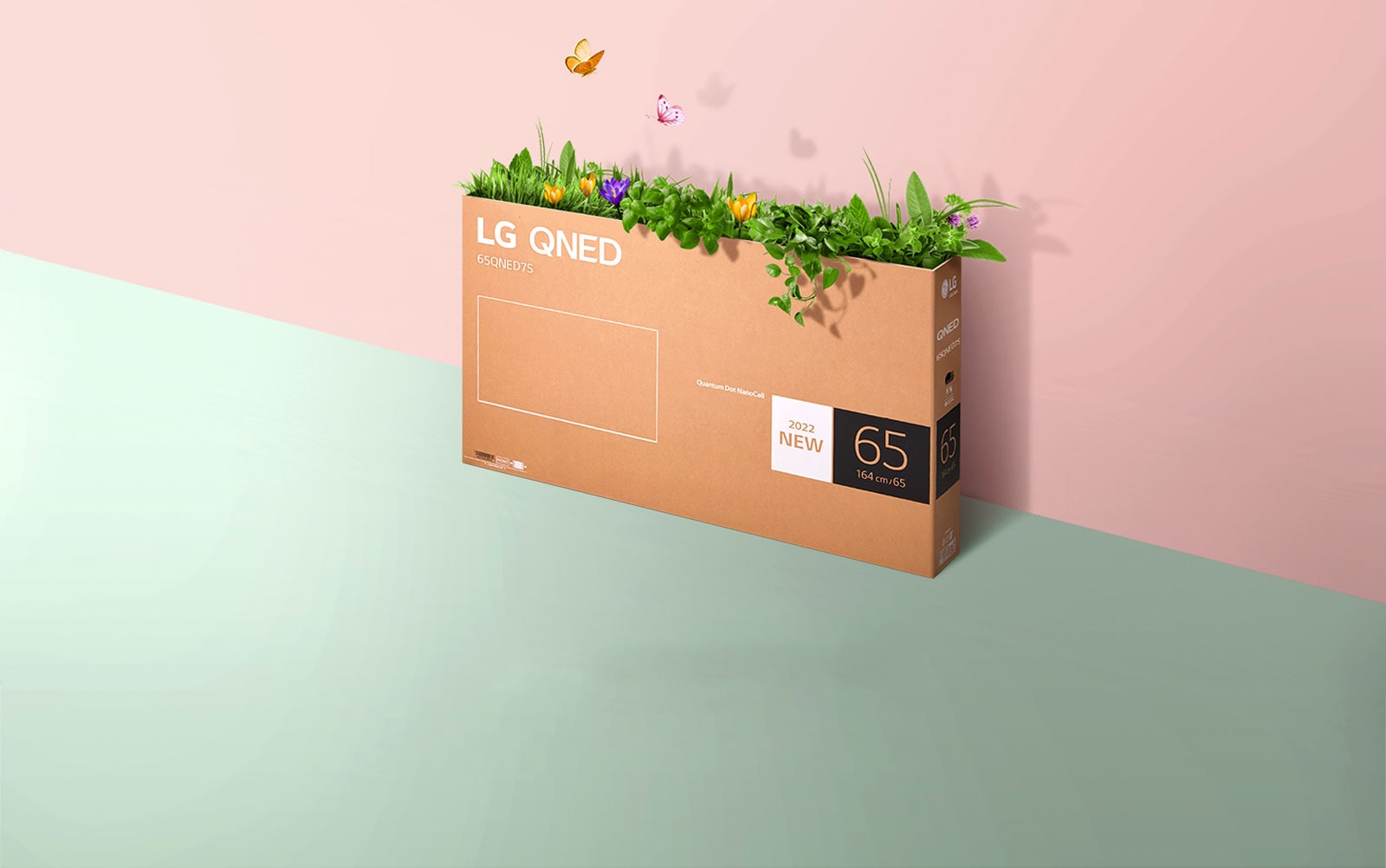 A QNED packaging box is placed on pink, green background and there is grass growing and butterflies coming out from its inside. 