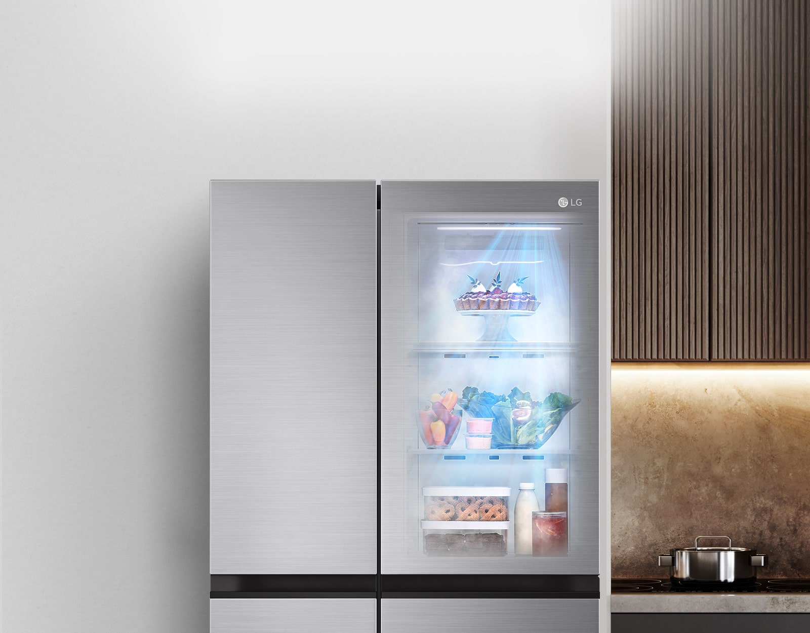 The front view of a black InstaView refrigerator with the light on inside. The contents of the refrigerator can be seen through the InstaView door. Blue rays of light shine down over the contents from the DoorCooling function. 