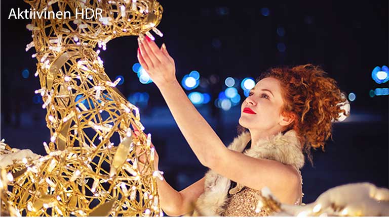 Tässä kortissa kuvaillaan Active HDR:ää. Elokuvatasoinen kuva naisesta, joka koskettaa veistosta.