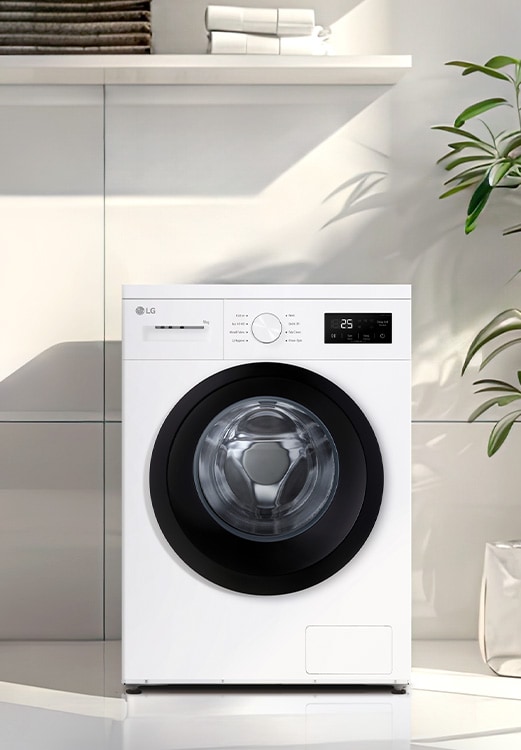  Edestä täytettävä pesukone moderniin pyykinpesutilaan asetettuna